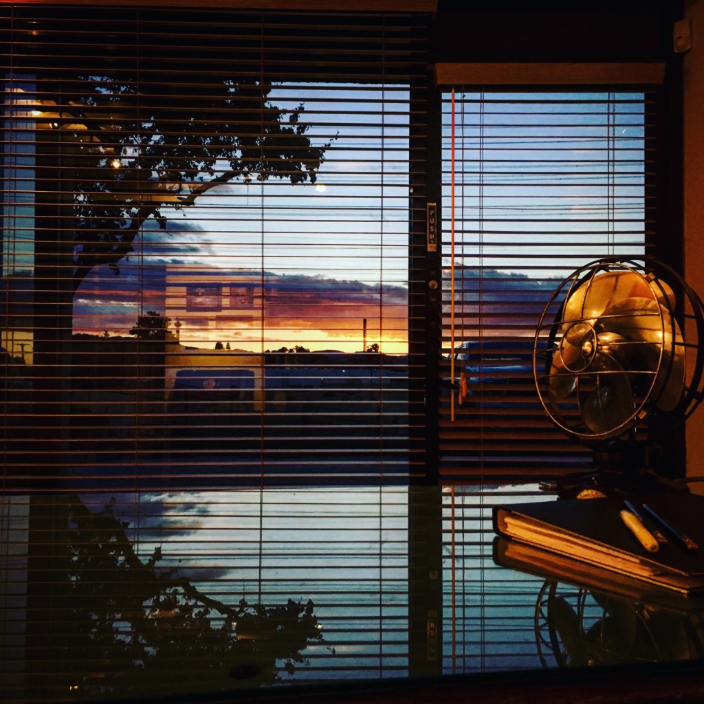 Front lobby desk beside a window with sunset light entering the Sound Sculpture workspace