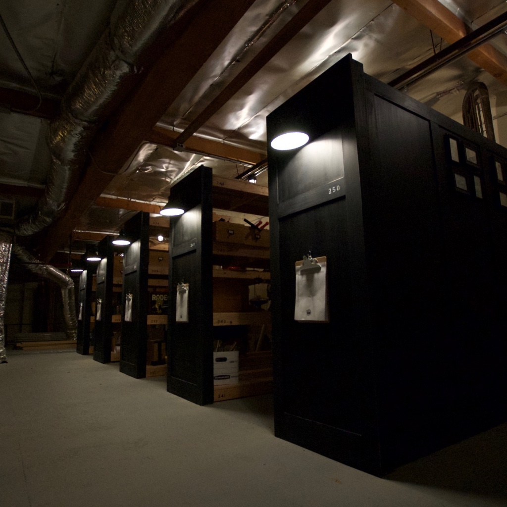 Row of tall black storage cabinets storing sound effect props.