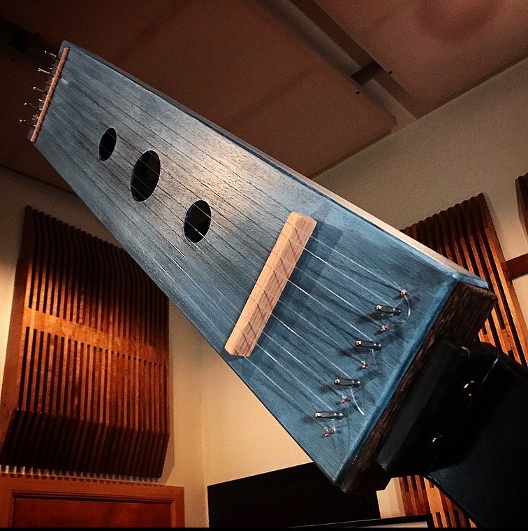 Handcrafted wooden stringed instrument designed for experimental soundmaking.