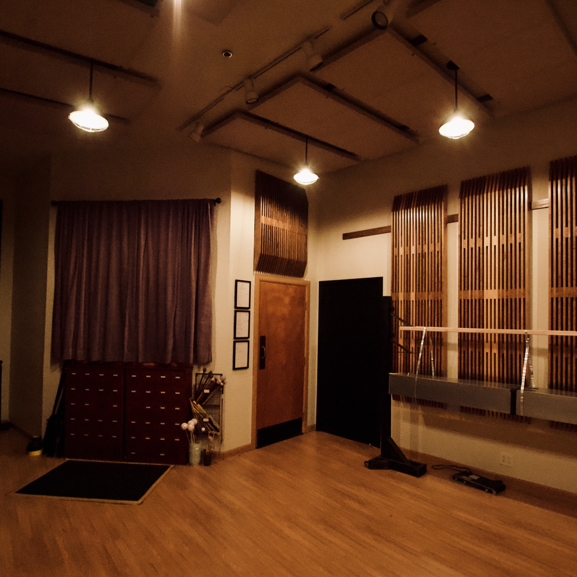 Recording studio interior with wood floors and acoustic treatment.