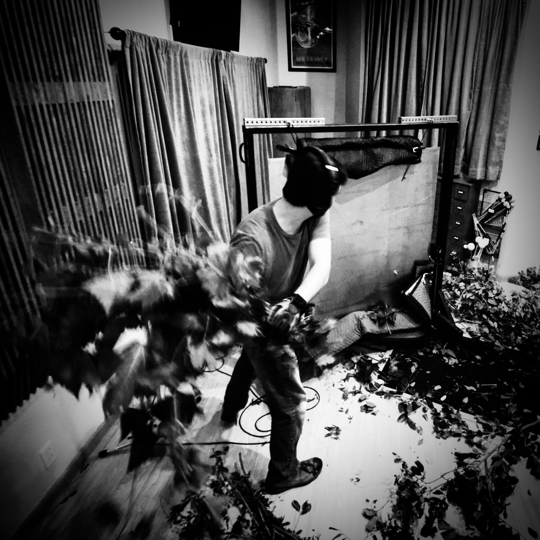 Sound artist recording foliage movement effects using physical materials in a studio.